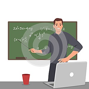 Young high school male teacher teach math online through laptop in classroom.