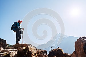 Young hiker backpacker female on cliff edge enjoying the Thamserku 6608m mountain during high altitude Acclimatization walk.