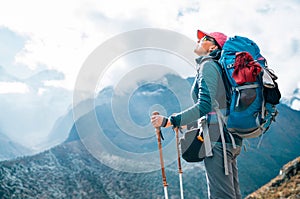 Young hiker backpacker female enjoying the valley and mountains view during high altitude Acclimatization walk. Everest Base Camp photo