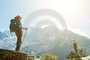 Young hiker backpacker female using trekking poles enjoying mountain view during high altitude Acclimatization walk. Everest Base photo