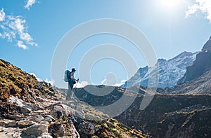 Young hiker backpacker man enjoying valley view in Makalu Barun Park route near Khare during high altitude acclimatization walk. photo