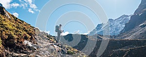 Young hiker backpacker man enjoying valley view in Makalu Barun Park route near Khare during high altitude acclimatization walk.