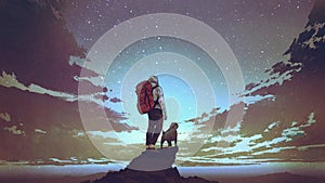 Young hiker and dog looking at the sky