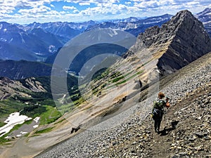 A young hiker exploring the Rocky Mountains on a backcountry hike along the spectacular Northover Ridge trail in Kananaskis