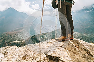 Young hiker female standind in cliff edge and enjoying the Imja Khola valley during an Everest Base Camp EBC trekking route near photo