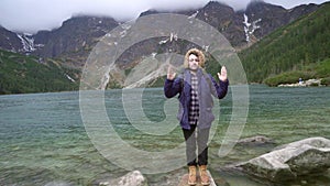 Young hiker meditating and making stupid faces in the mountains