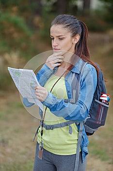 Young hiker searching map