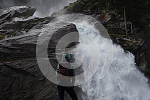 Young hiker stands in front of the Krimmler waterfalls