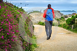 Young hiker woman with backpack in nature, Ploumanach, France