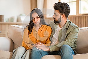 Young Hindu couple having a serious conversation at home