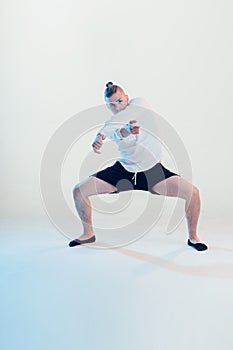 Young hip-hop dancer posing at studio