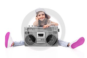 Young hip hop girl listening music on boombox retro radio, ghetto blaster, isolated on white background