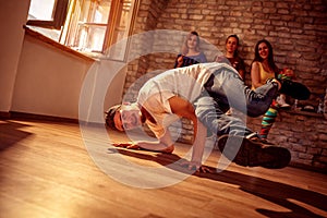 Young hip hop men performs break dancing moves