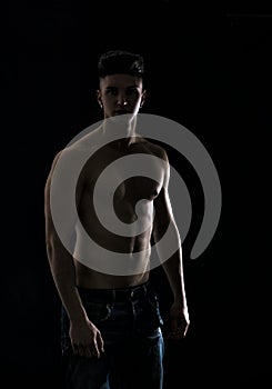 Young hip man in jeans, shirtless, isolated on