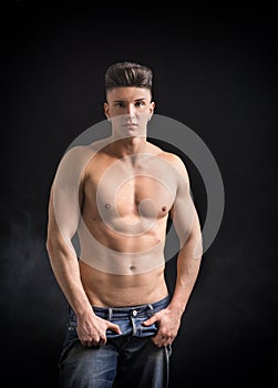 Young hip man in jeans, shirtless, isolated on