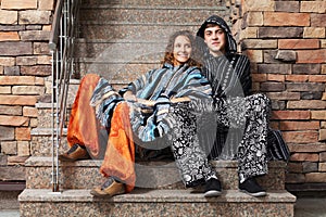 Young hippie couple sitting on the steps