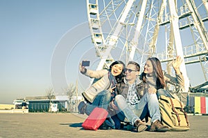 Young hipster best friends taking a selfie at luna park