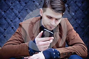 Young hipster businessman talking phone outdoors