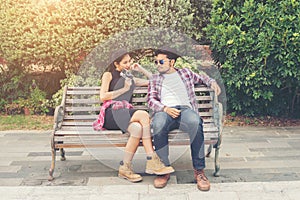 Young hipster couple teenagers in love in the city, Summer holiday enjoyment together.