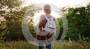 Young hipster girl enjoy sunset. Travel woman with backpack