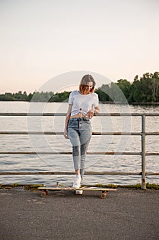 Young hipster girl with longboard