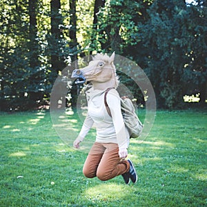 Young hipster horse mask woman in autumn