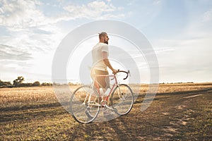 Young hipster man with bicycle