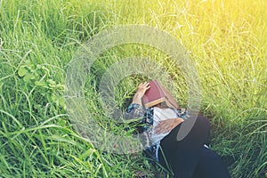 Young hipster man lying down on grassland napping tired after re photo