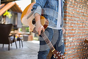 Young hipster man practiced guitar in the park,happy and enjoy playing guitar. photo
