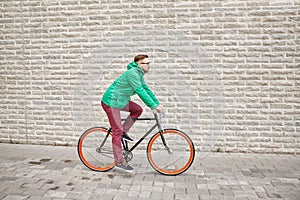 Young hipster man riding fixed gear bike