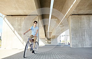 Young hipster man riding fixed gear bike