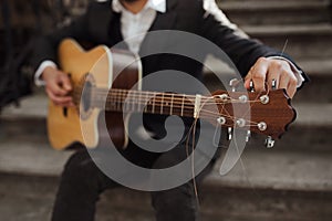 Young hipster playing guitar.