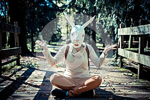 Young hipster rabbit mask woman in autumn