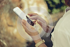 Young hipster woman using smart phone in the street.