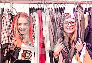 Young hipster women at clothes flea market - Best friends fun