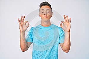 Young hispanic boy wearing casual clothes relax and smiling with eyes closed doing meditation gesture with fingers