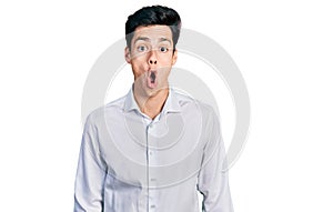 Young hispanic business man wearing business clothes afraid and shocked with surprise expression, fear and excited face