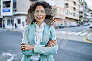 Young hispanic business woman wearing professional look smiling confident at the city