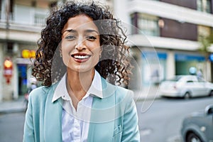 Young hispanic business woman wearing professional look smiling confident at the city