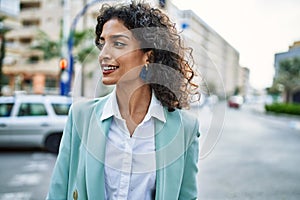 Young hispanic business woman wearing professional look smiling confident at the city