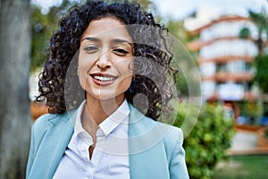 Young hispanic business woman wearing professional look smiling confident at the city