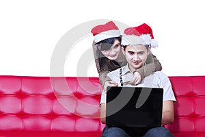 Young hispanic couple christmas shopping online