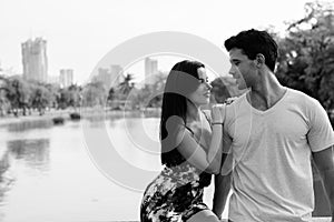 Young Hispanic couple relaxing in the park together