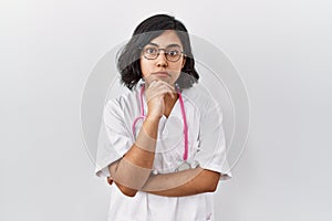 Young hispanic doctor woman wearing stethoscope over isolated background looking confident at the camera with smile with crossed