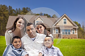 Young Hispanic Family in Front of Their New Home