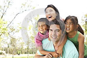 Young Hispanic Family In Park