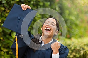 Young hispanic female graduate at her graduation photo