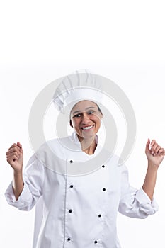 Young hispanic girl chef on white background dancing very happy and excited with raised arms, smiling for success. Vertical format