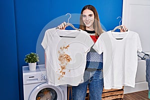 Young hispanic girl holding clean white t shirt and t shirt with dirty stain smiling with a happy and cool smile on face