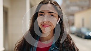 Young hispanic girl smiling confident using touchpad at street